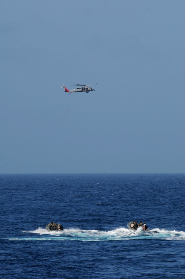 US Navy 110823-N-DU438-026 A MH-60S Sea Hawk helicopter from Helicopter Sea Combat Squadron (HSC) 9 hovers above U.S. Navy SEALs