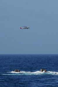 US Navy 110823-N-DU438-026 A MH-60S Sea Hawk helicopter from Helicopter Sea Combat Squadron (HSC) 9 hovers above U.S. Navy SEALs