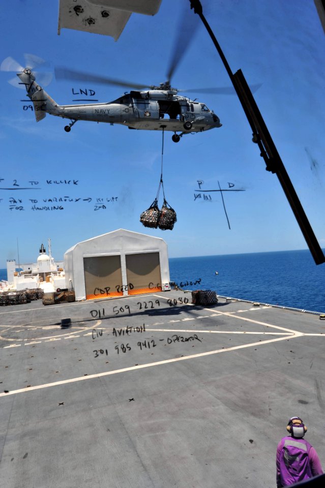 US Navy 110818-F-NJ219-158 An MH-60S Sea Hawk helicopter assigned to the Chargers of Helicopter Sea Combat Squadron (HSC) 26 transports cargo from