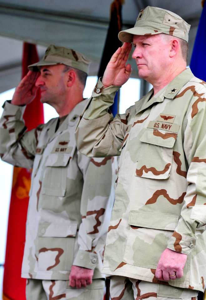 US Navy 110824-N-RF645-094 Rear Adm. David Woods and Rear Adm. Jeffrey Harbeson render hand salutes during the playing of the national anthem at th