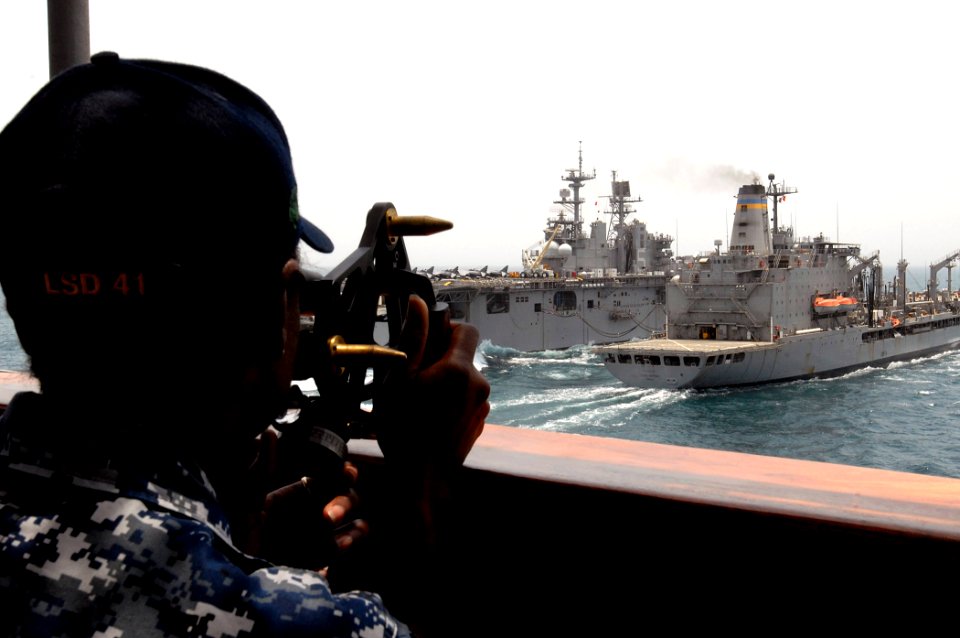 US Navy 110820-N-GH121-034 Operations Specialist 1st Class Lashanda Mack takes distance readings with a stadimeter while observing the amphibious a