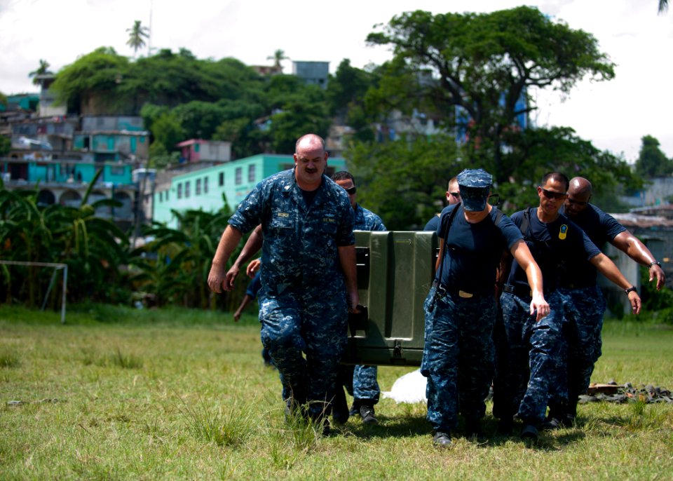 US Navy 110818-N-NY820-199 Sailors carry airlifted cargo to a surgical screening site at the Killick Haitian Coast Guard Base during Continuing Pro