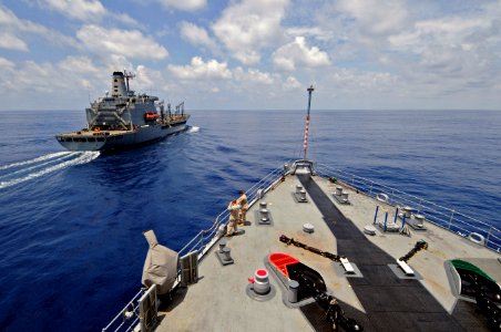 US Navy 110821-N-RC734-037 The amphibious dock landing ship USS Comstock (LSD 45), bottom, makes its approach alongside the Military Sealift Comman