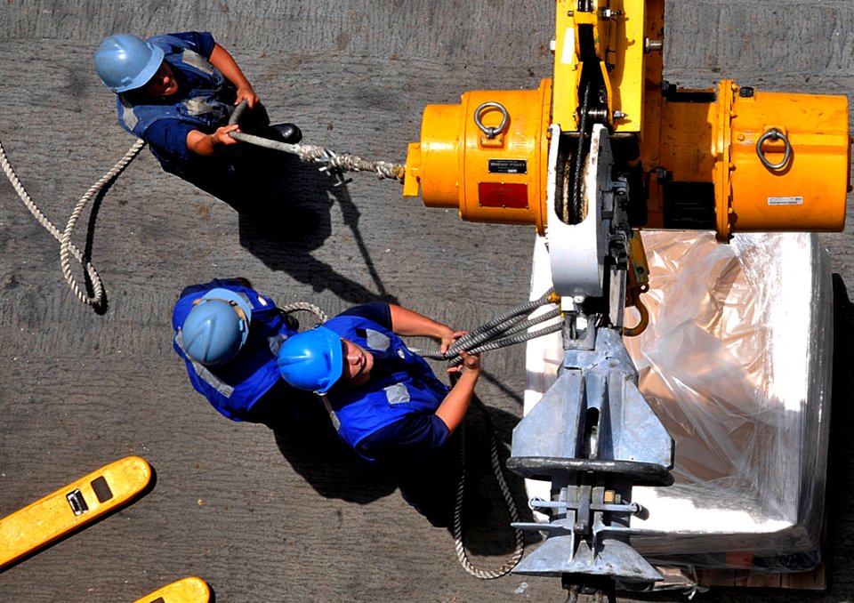 US Navy 110821-N-AG285-295 Sailors disconnect a pallet aboard the amphibious dock landing ship USS Whidbey Island (LSD 41) during an underway reple