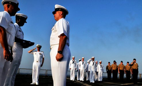 US Navy 110822-N-AG285-386 Capt. Eric Conzen, commanding officer of the amphibious dock landing ship USS Whidbey Island (LSD 41), left center photo