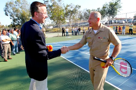 US Navy 110824-N-HW977-264 Steve Kappes, left, and Capt. Terry Auberry shake hands during a ribbon cutting event marking the completion of tennis c