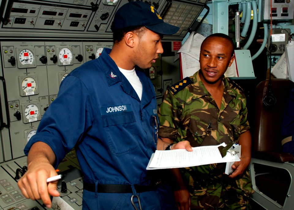 US Navy 110822-N-OV802-022 A Sailor explains his watch standing studies to a Tanzanian navy Capt