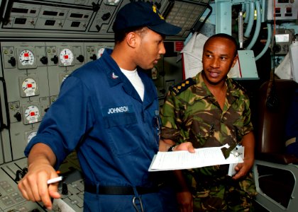 US Navy 110822-N-OV802-022 A Sailor explains his watch standing studies to a Tanzanian navy Capt
