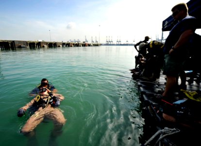 US Navy 110819-N-KB666-088 Navy Diver 3rd Class Bryan Myers, rear, assigned to company 23 of Mobile Diving and Salvage Unit (MDSU) 2, conducts in w photo