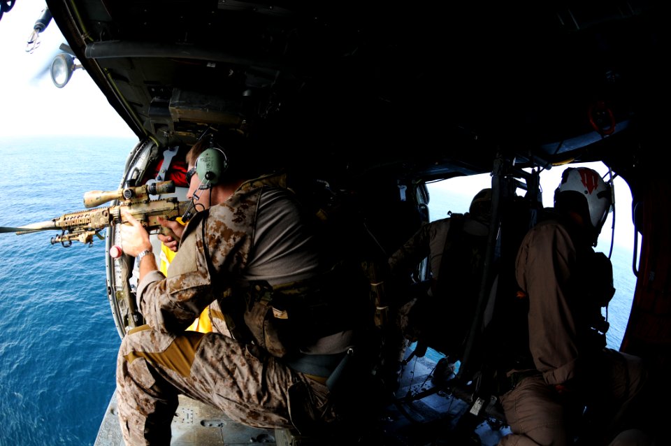 US Navy 110822-N-XE109-945 A Navy SEAL fires an MK-11 sniper rifle from an MH-60S Sea Hawk helicopter