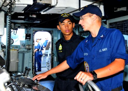 US Navy 110822-N-XR557-099 Boatswain's Mate 3rd Class Mark Denton, right, talks to Republic of Singapore navy 2nd Lt. Dominic Lew