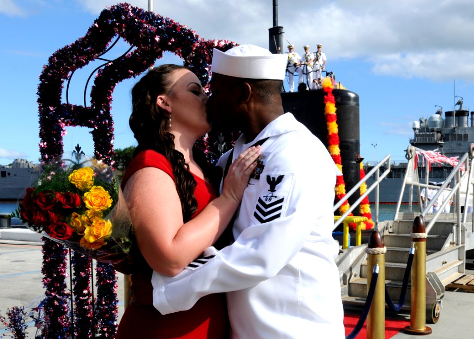 US Navy 110824-N-UK333-077 A Sailor kisses his girlfriend on the pier after returning from a six-month deployment