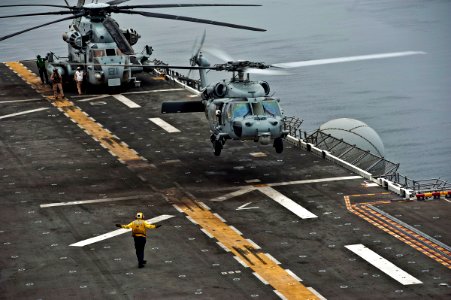 US Navy 110821-N-DX615-058 An MH-60S Sea Hawk helicopter assigned to the Wild Cards of Helicopter Sea Combat Squadron (HSC) 23 lands aboard the amp