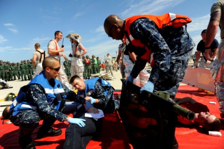US Navy 110826-N-KK192-073 Sailors load a victim onto a stretcher during a mass accident response exercise photo