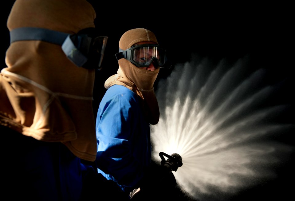 US Navy 110824-N-DR144-653 Japan Maritime Self-Defense Force sailors practice manning a hose at the Center for Naval Engineering Firefighting Schoo