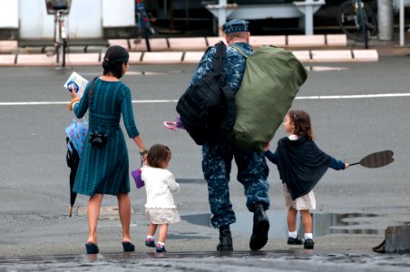 US Navy 110822-N-SF508-051 IT1 Christopher Binning walks off the pier with his family, heading home after a summer patrol