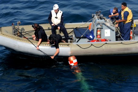US Navy 110822-N-QL471-375 Sailors retrieve a MK-46 recoverable exercise torpedo during a weapons exercise aboard the guided-missile destroyer USS