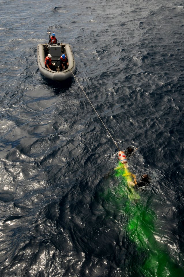 US Navy 110822-N-XQ375-763 Sailors in a rigid-hull inflatable boat from the guided-missile destroyer USS Mitscher (DDG 57) recover a MK-46 recovera