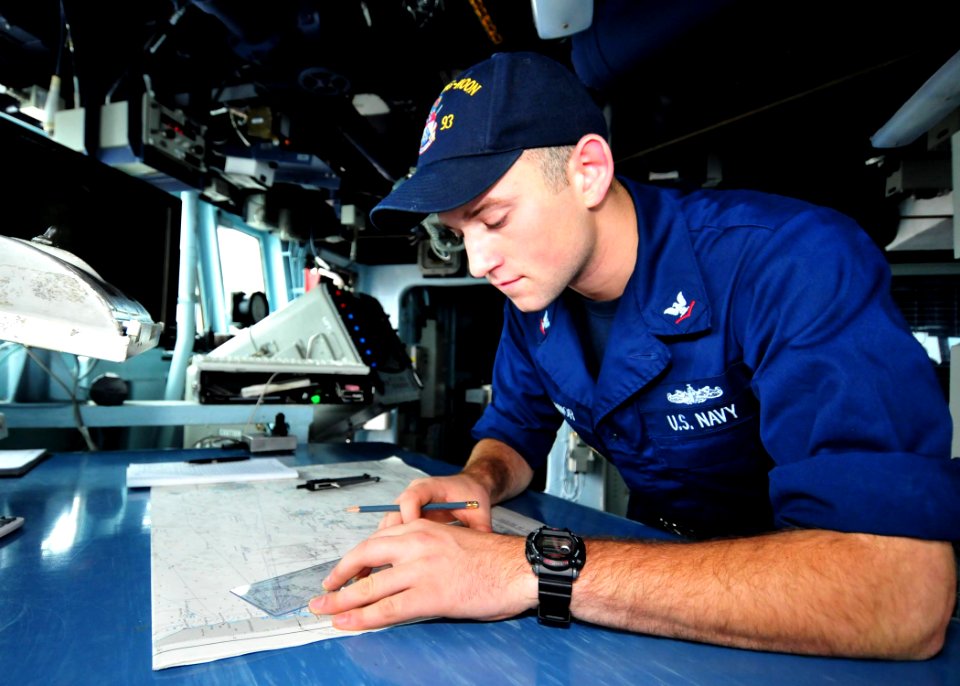 US Navy 110825-N-XR557-106 Quartermaster 3rd Class Kendall O'Connor plots a fix verifying the ship's position aboard the guided-missile destroyer U