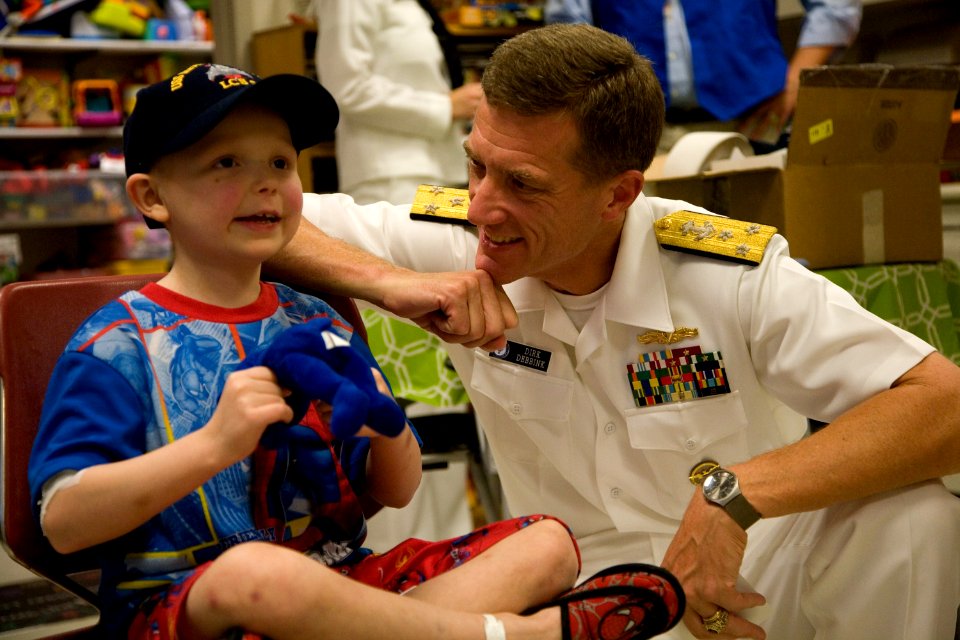 US Navy 110829-N-YM440-172 Vice Adm. Dirk Debbink, Chief of Navy Reserve, visits a patient during a Caps For Kids event at Cincinnati Children's Ho