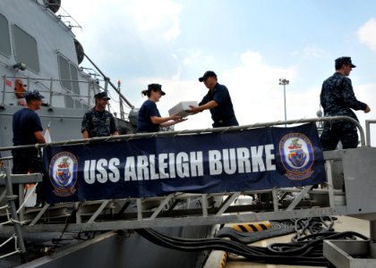 US Navy 110824-N-QY430-067 Sailors from the guided-missile destroyer USS Arleigh Burke (DDG 51) load supplies as the ship makes ready for the ship'