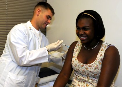 US Navy 110827-N-KA543-005 Hospital Corpsman 2nd Class Chris Dunbar, assigned to Naval Medical Center San Diego, gives a patient a tetanus, diphthe