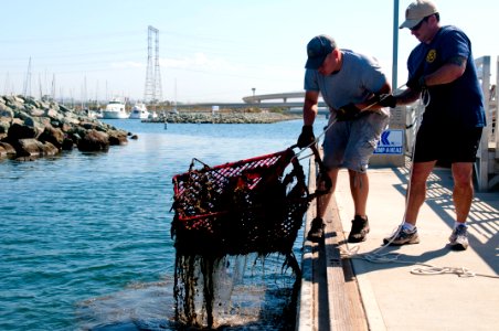 US Navy 110827-N-PB383-130 Navy divers assigned to Mobile Diving and Salvage Unit (MDSU) 1 pull a shopping cart out of San Diego Bay during Operati