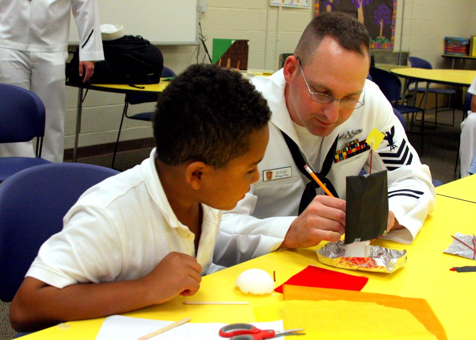 US Navy 110830-N-NT881-076 Fire Control Technician 1st Class, Shane Adkins assists a Taft Elementary School student learn the principles of buoyanc