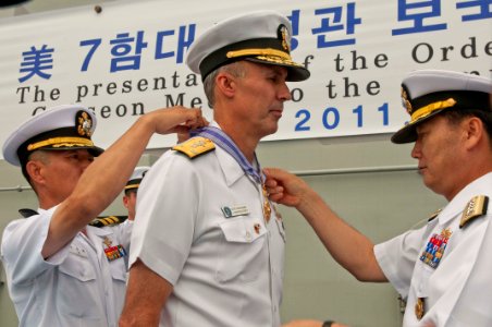 US Navy 110825-N-CZ945-001 Republic of Korea navy Chief of Naval Operations Adm. Kim Sung-chan, right, presents the Republic of Korea Order of Nati