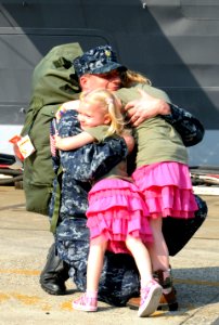 US Navy 110829-N-XG305-376 Chief Intelligence Specialist Marc De St. Aubin hugs his daughters after USS Blue Ridge (LCC 19) arrives at Commander, F