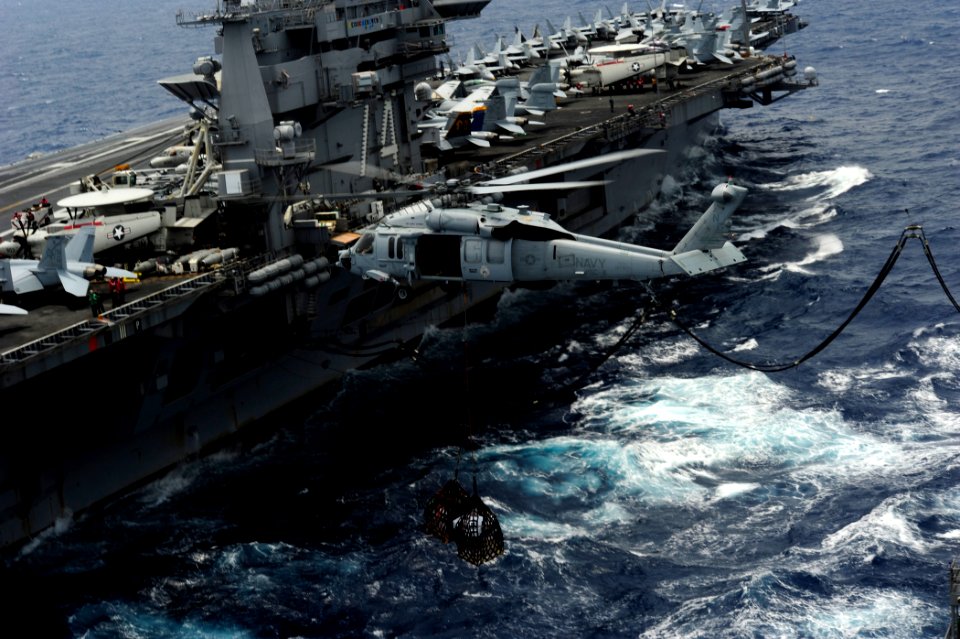 US Navy 110830-N-ZZ999-780 An MH-60S Sea Hawk helicopter assigned to the Eightballers of Helicopter Sea Combat Squadron (HSC) 8 transfers cargo dur