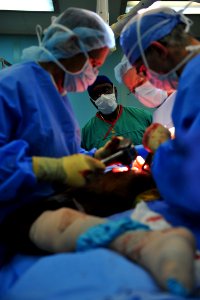 US Navy 110826-F-NJ219-185 A Haitian orthopedic surgeon observes a surgery aboard USNS Comfort (T-AH 20) during Continuing Promise 2011 photo