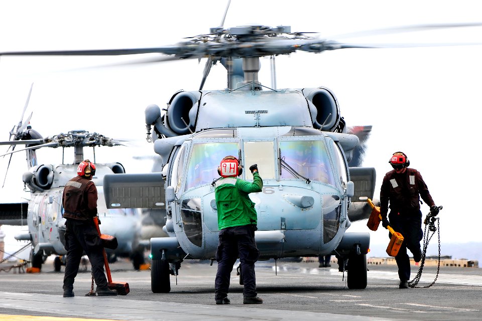 US Navy 110826-N-EE987-144 Sailors assigned to the aircraft carrier USS Ronald Reagan (CVN 76) ready an SH-60F Sea Hawk helicopter for liftoff