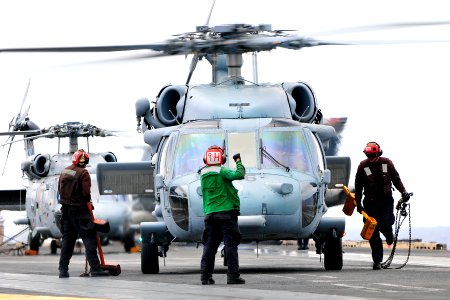 US Navy 110826-N-EE987-144 Sailors assigned to the aircraft carrier USS Ronald Reagan (CVN 76) ready an SH-60F Sea Hawk helicopter for liftoff