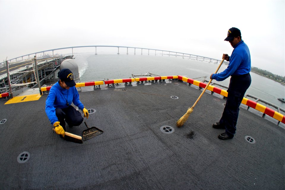 US Navy 110830-N-ZC343-498 Sailors clean the starboard aircraft elevator aboard USS Bonhomme Richard (LHD 6) as the ship gets underway to load ammu