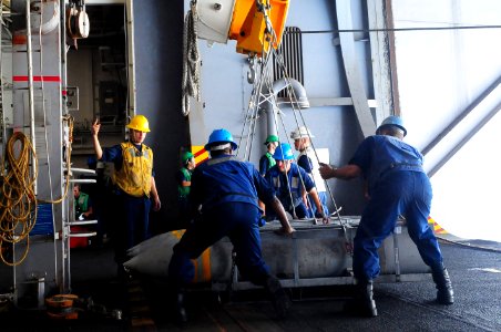 US Navy 110828-N-UO379-029 Sailors rig high explosive bombs for transport during an ordnance handling evolution aboard USS Ronald Reagan (CVN 76)