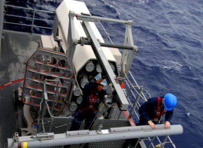 US Navy 110826-N-KF029-057 Fire Controlmen transfer missiles from a Nato Sea Sparrow Missile System during a weapons movement evolution aboard the