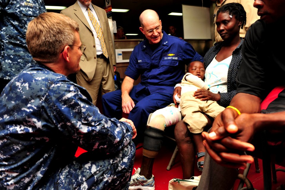 US Navy 110828-F-NJ219-128 Rear Adm. Steven Ratti visits with a patient during a tour of USNS Comfort (T-AH 20)