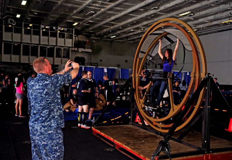 US Navy 110827-N-SF704-093 Senior Chief Hospital Corpsman Paul Christensen photographs his daughter on a human gyroscope during a friends and famil