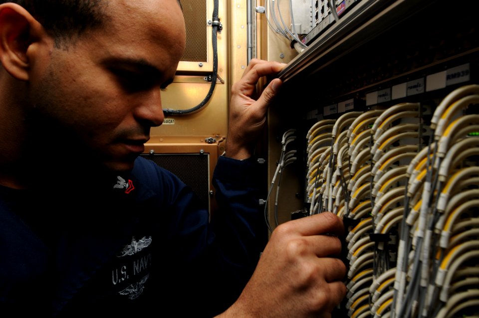 US Navy 110828-N-XE109-022 Fire Controlman 2nd Class Jose A. Sotocora performs maintenance on the ship's self defense system aboard the aircraft ca