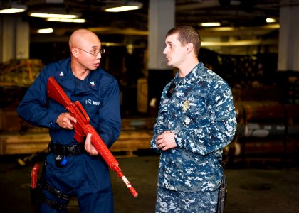 US Navy 110831-N-ZZ999-008 Electronics Technician 3rd Class Rudy Picardo, left, and Master-at-Arms 2nd Class Robert Fleming participate in an anti