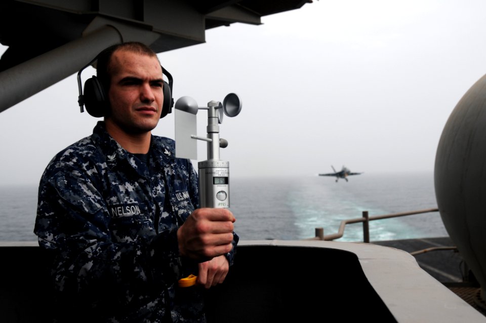 US Navy 110827-N-TU894-075 Aerographer's Mate 3rd Class Joshua C. Nelson takes weather observations to determine ceiling visibility and sea state a