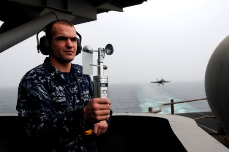 US Navy 110827-N-TU894-075 Aerographer's Mate 3rd Class Joshua C. Nelson takes weather observations to determine ceiling visibility and sea state a