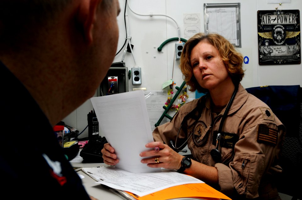 US Navy 110827-N-XE109-016 Cmdr. Kimberly P. Toone, senior medical officer aboard the aircraft carrier USS George H.W. Bush (CVN 77), reviews medic