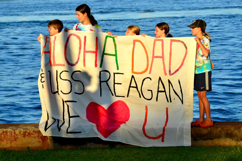 US Navy 110831-N-RI844-087 Friends and family members of Sailors aboard Nimitz-class aircraft carrier USS Ronald Reagan (CVN 76) greet the ship as photo