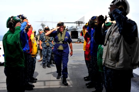 US Navy 110828-F-NJ219-023 Rear Adm. Steven Ratti salutes sideboys as he embarks USNS Comfort (T-AH 20) for a tour during Continuing Promise 2011 photo