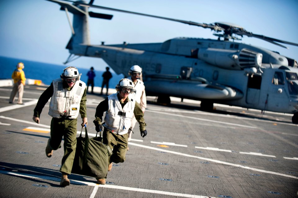 US Navy 110901-N-PB383-717 Marines assigned to the 11th Marine Expeditionary Unit (11th MEU) retrieve cargo from a CH-53E Super Stallion helicopte