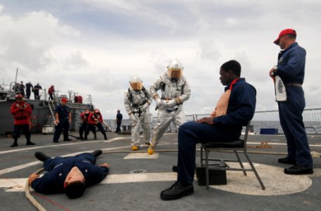 US Navy 110901-N-XQ375-176 Sailors participate in a damage control exercise simulating a helicopter crash aboard the guided-missile destroyer USS M photo