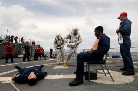 US Navy 110901-N-XQ375-176 Sailors participate in a damage control exercise simulating a helicopter crash aboard the guided-missile destroyer USS M