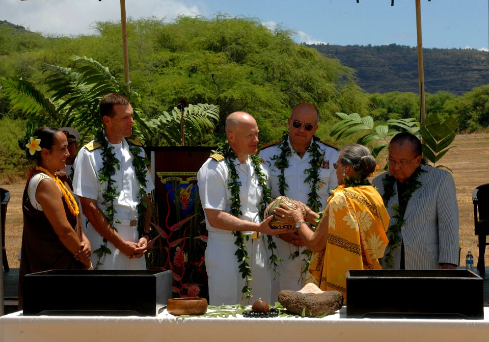 US Navy 110829-N-YU572-034 Waimea kupuna (elder) Aletha Kaohi hands Capt. Nicholas Mongillo, commanding officer of the Pacific Missile Range Facili